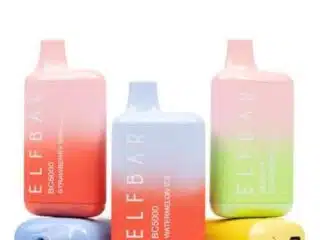 Three Elf Bar BC5000 disposables with two lying down on white background